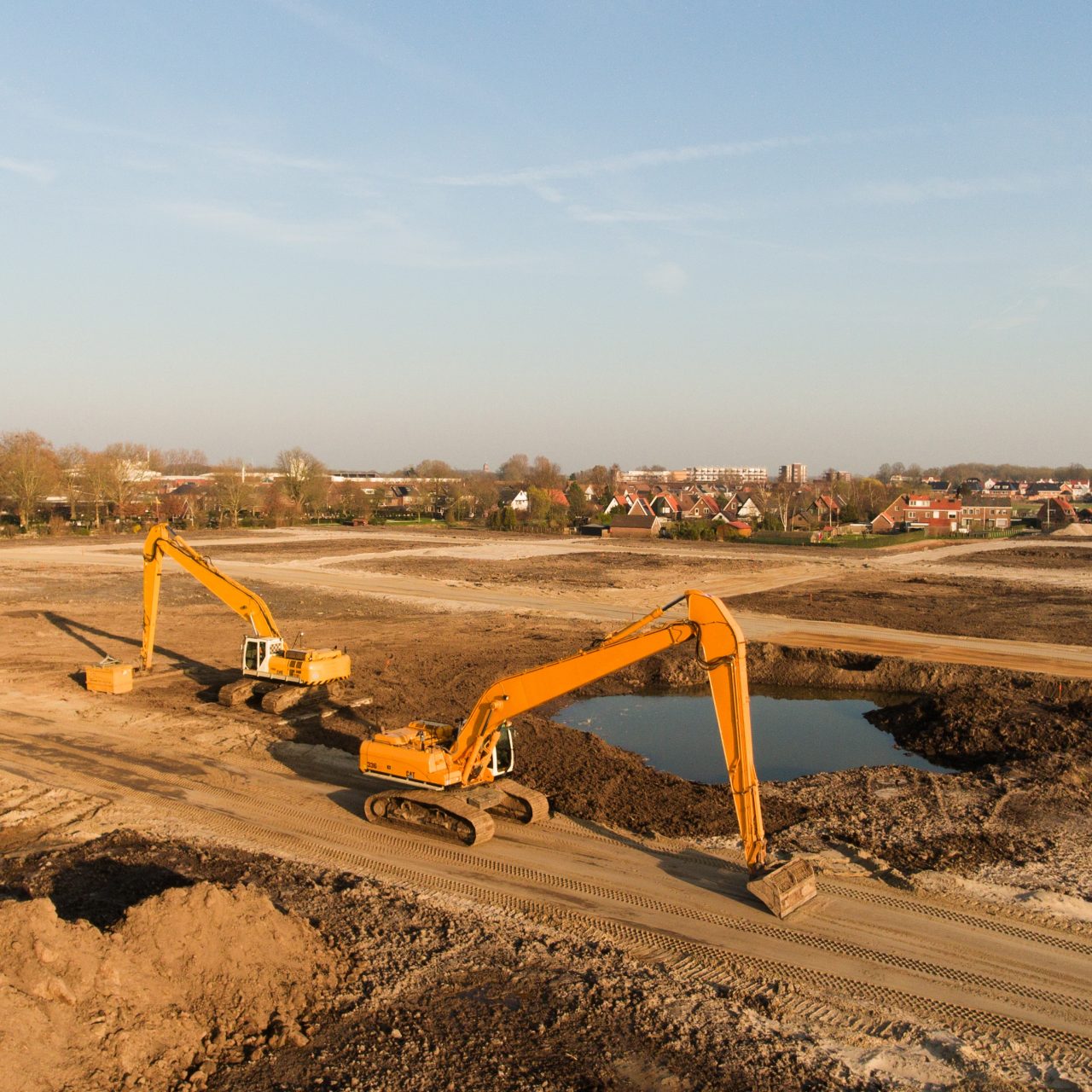 A high angle shot of two excavators on a building site
